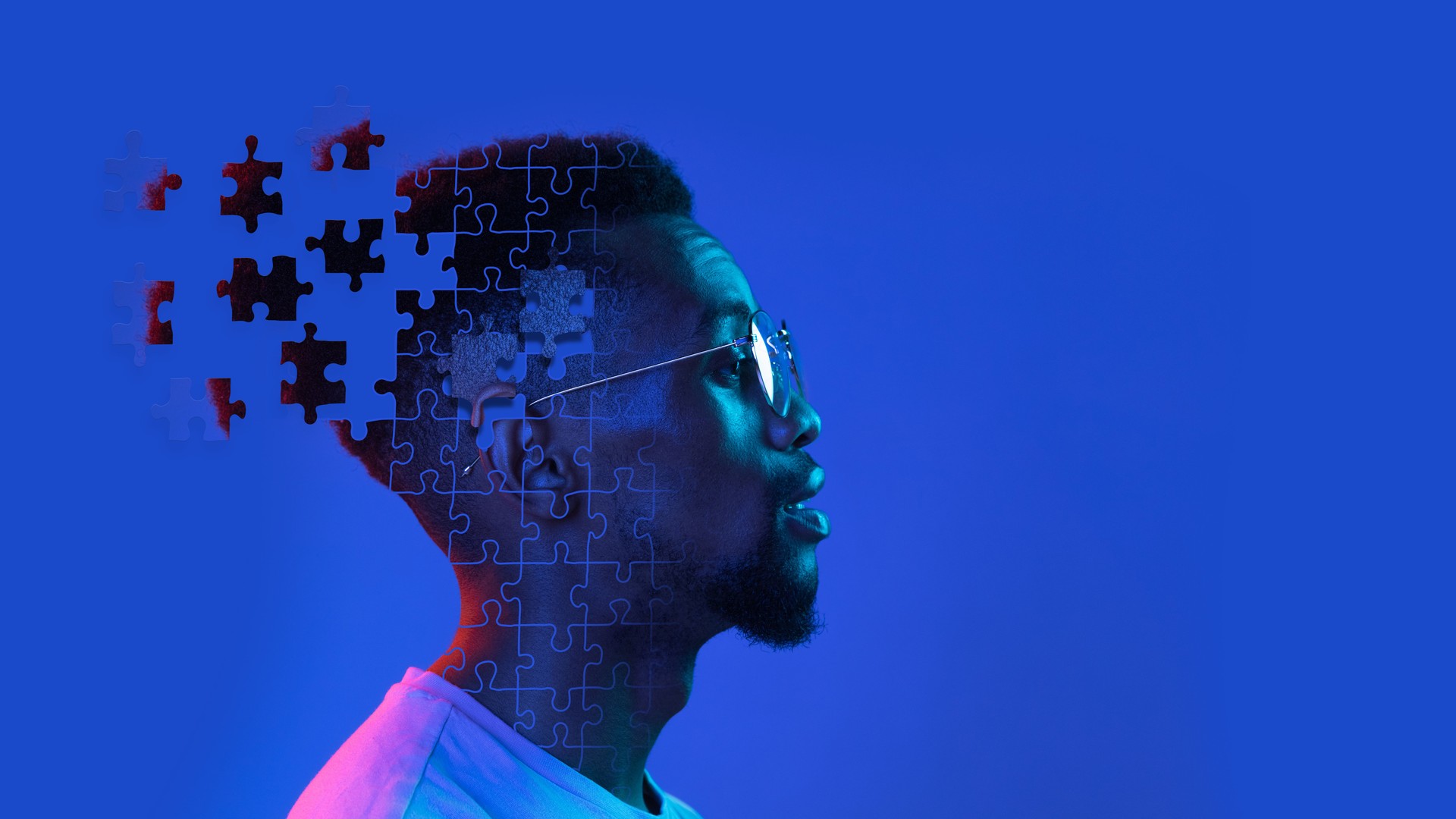 Profile, side view of young man's head made of flying pieces of puzzle, modern art collage. Concept of diversity, mental health, emotion, inner world, creativity